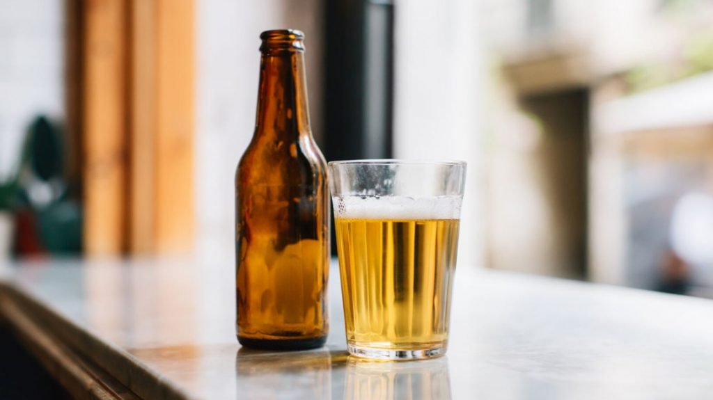 a glass and bottle of beer